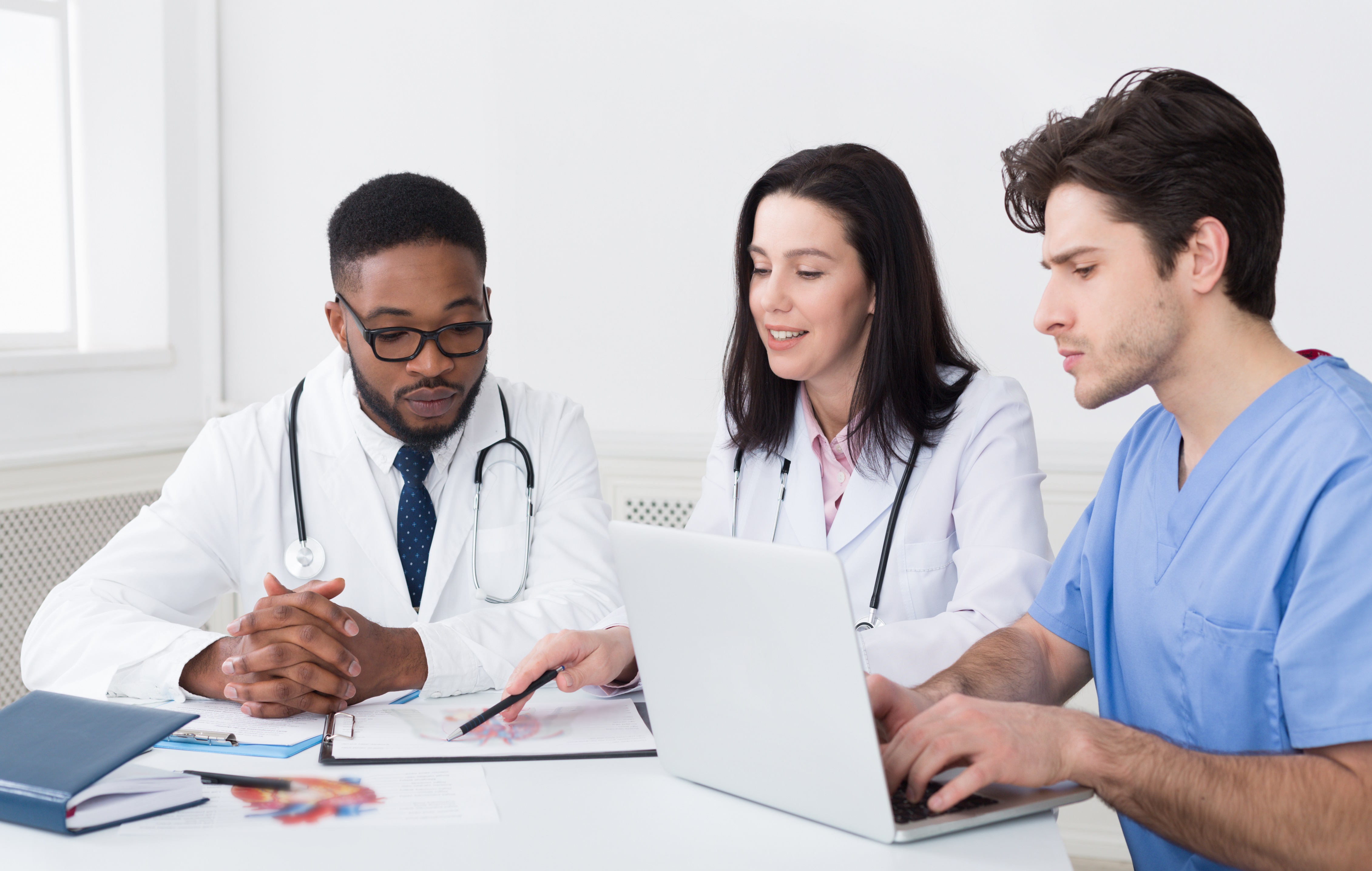 Image of medical students talking with each other at a table