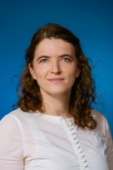  Photo of Dr. Sophia Kogan against a blue background
